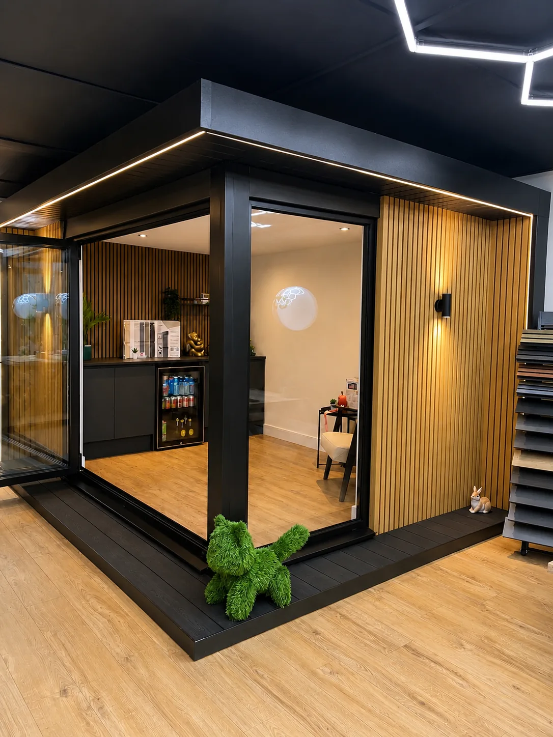 A display garden room at the showroom, slatted timber lining and hex lighting inside