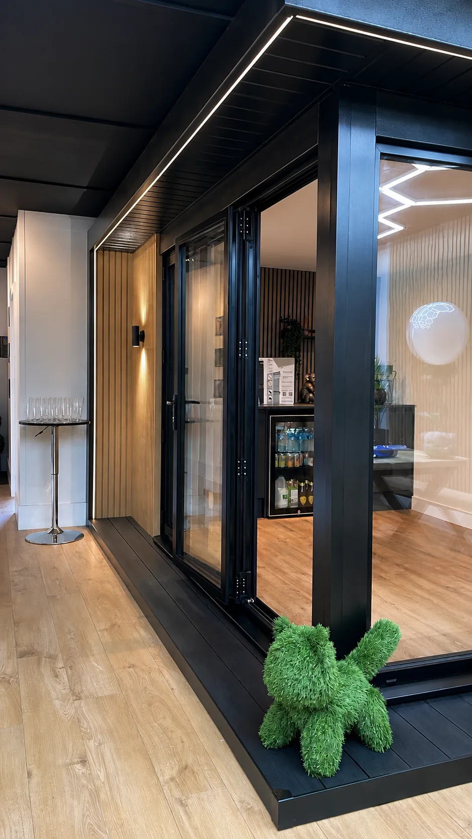 A display garden room at the Blackpool showroom, doors folded open onto the decking